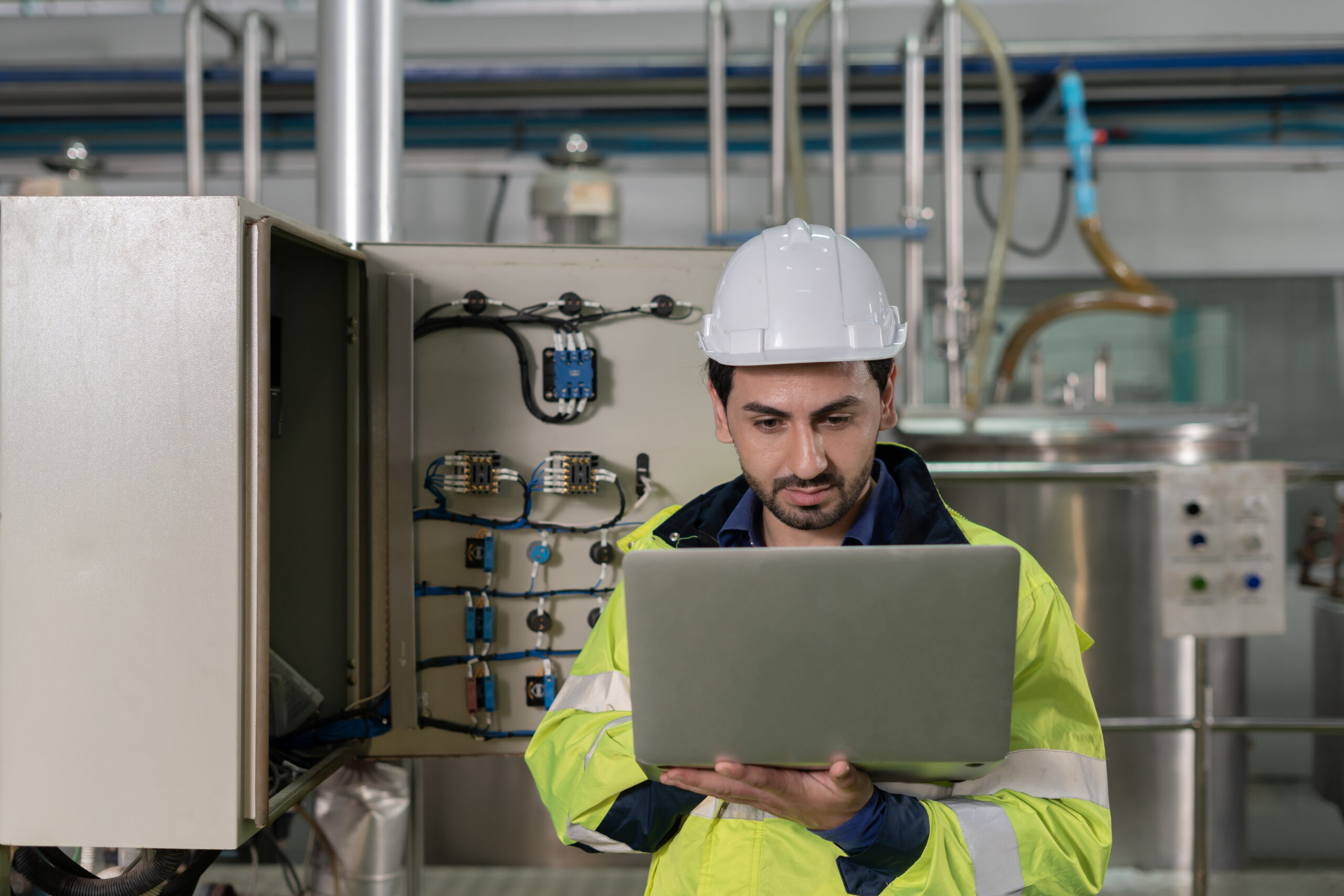 Mechanic or maintenance or electrical engineer checking main electrical control systems industrial plant. Utility fore man daily check power systems in process. Main Distribution Board, Switchboards